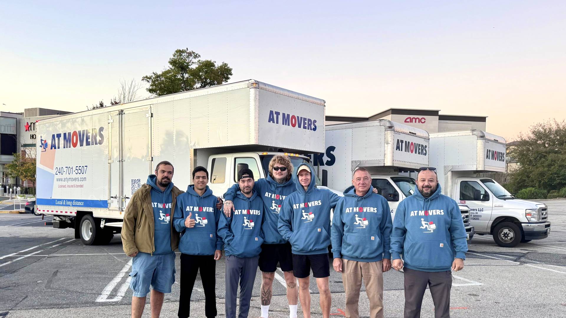The AT Movers crew in front of their moving trucks