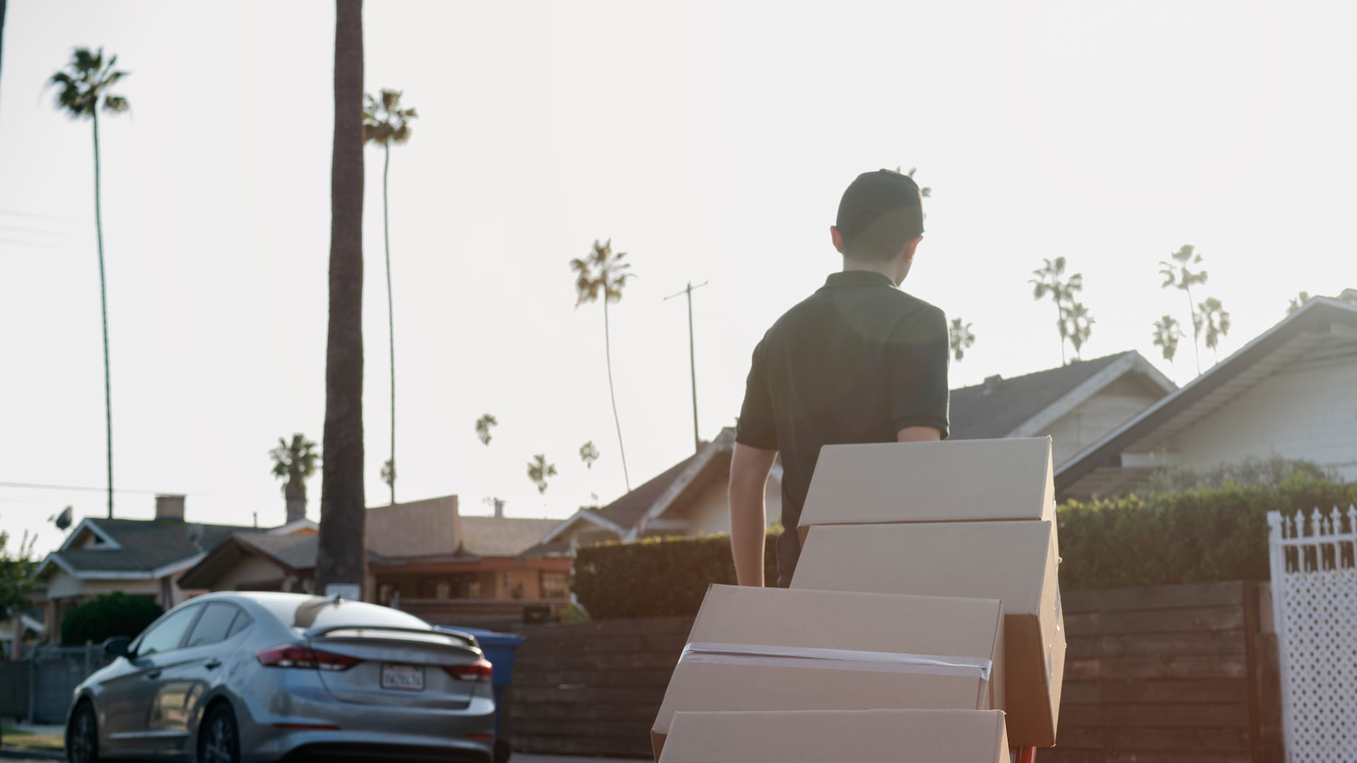 Movers with boxes near house