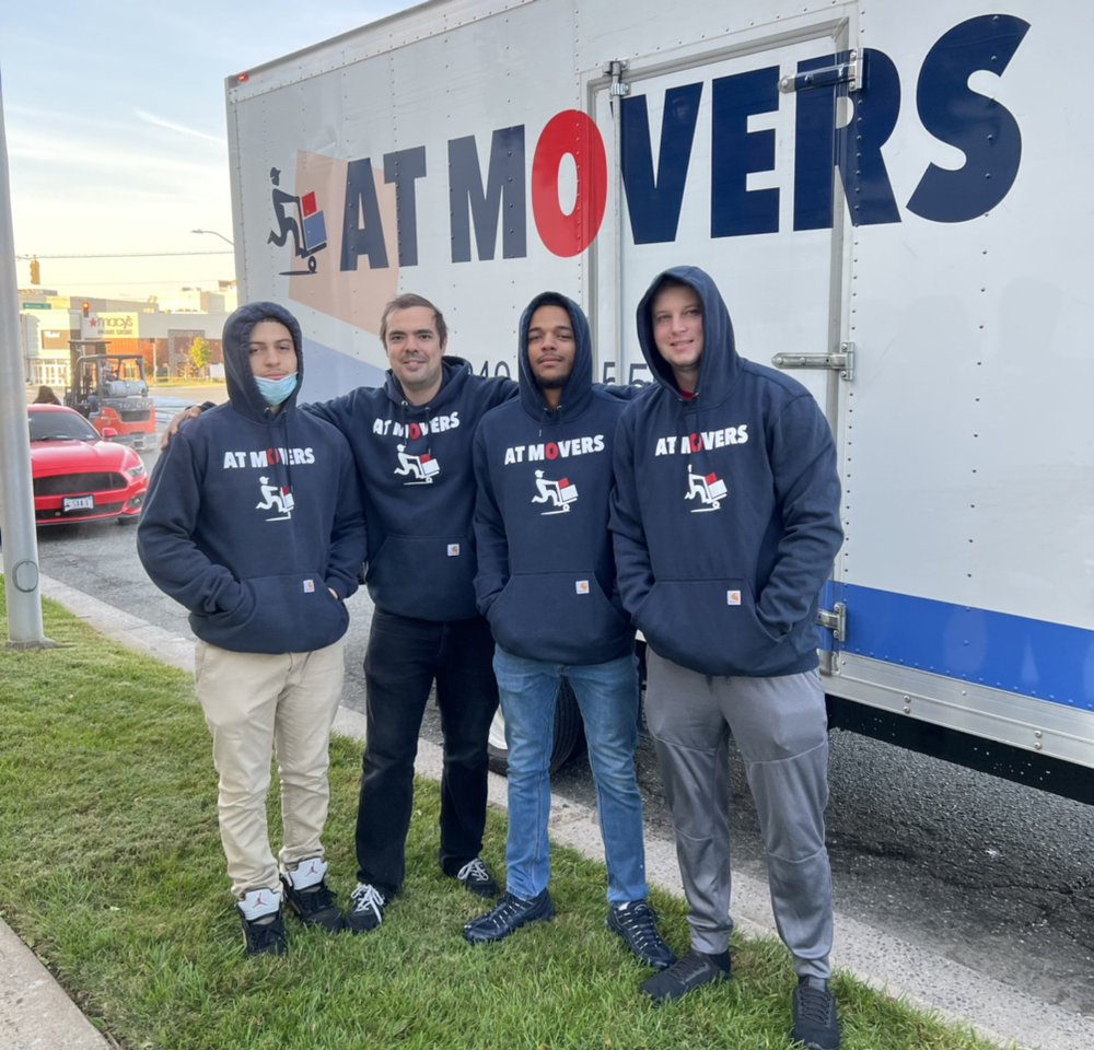 AT Movers wrapping belongings for transport