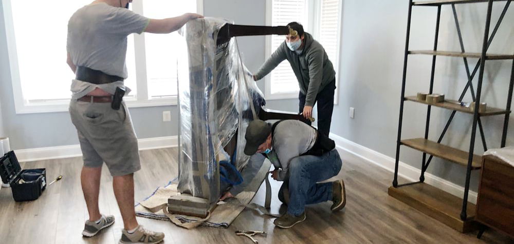 The AT Movers team packs the client's belongings