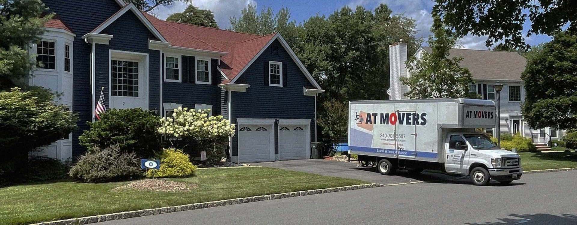 AT Movers Moving Truck Near House