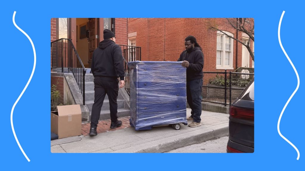 Movers preparing a wrapped dresser for a single-item furniture move in DC